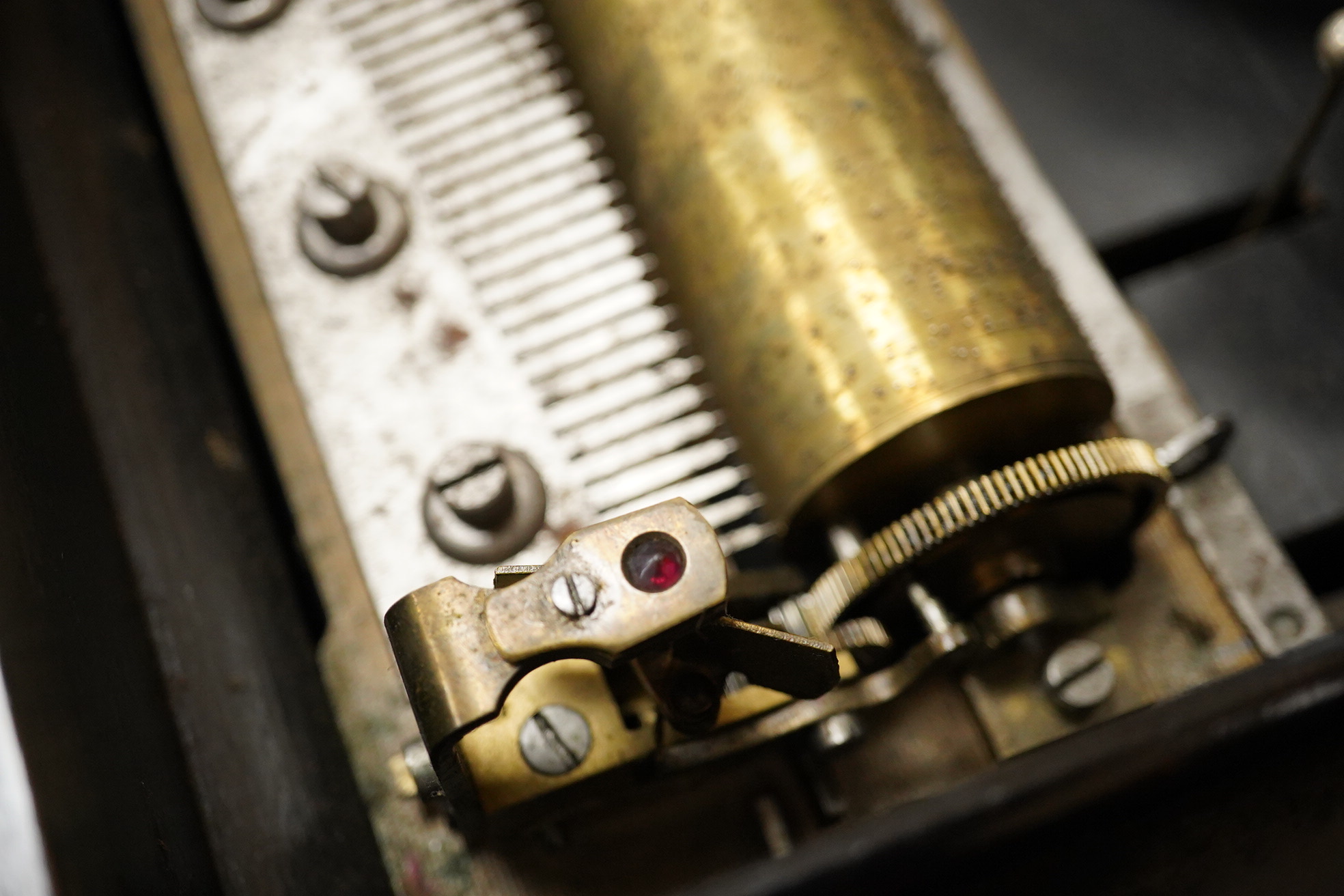 A mid-19th century inlaid and ebonised rosewood Swiss cylinder music box playing eight airs on a cylinder and three bells, card label to the inside of the lid listing the airs, complete with all teeth to the comb, cylind